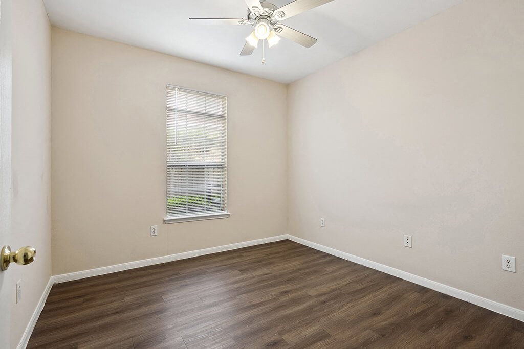 Bedroom with wood flooring at Fountains at Tidwell and The Enclave in Houston TX